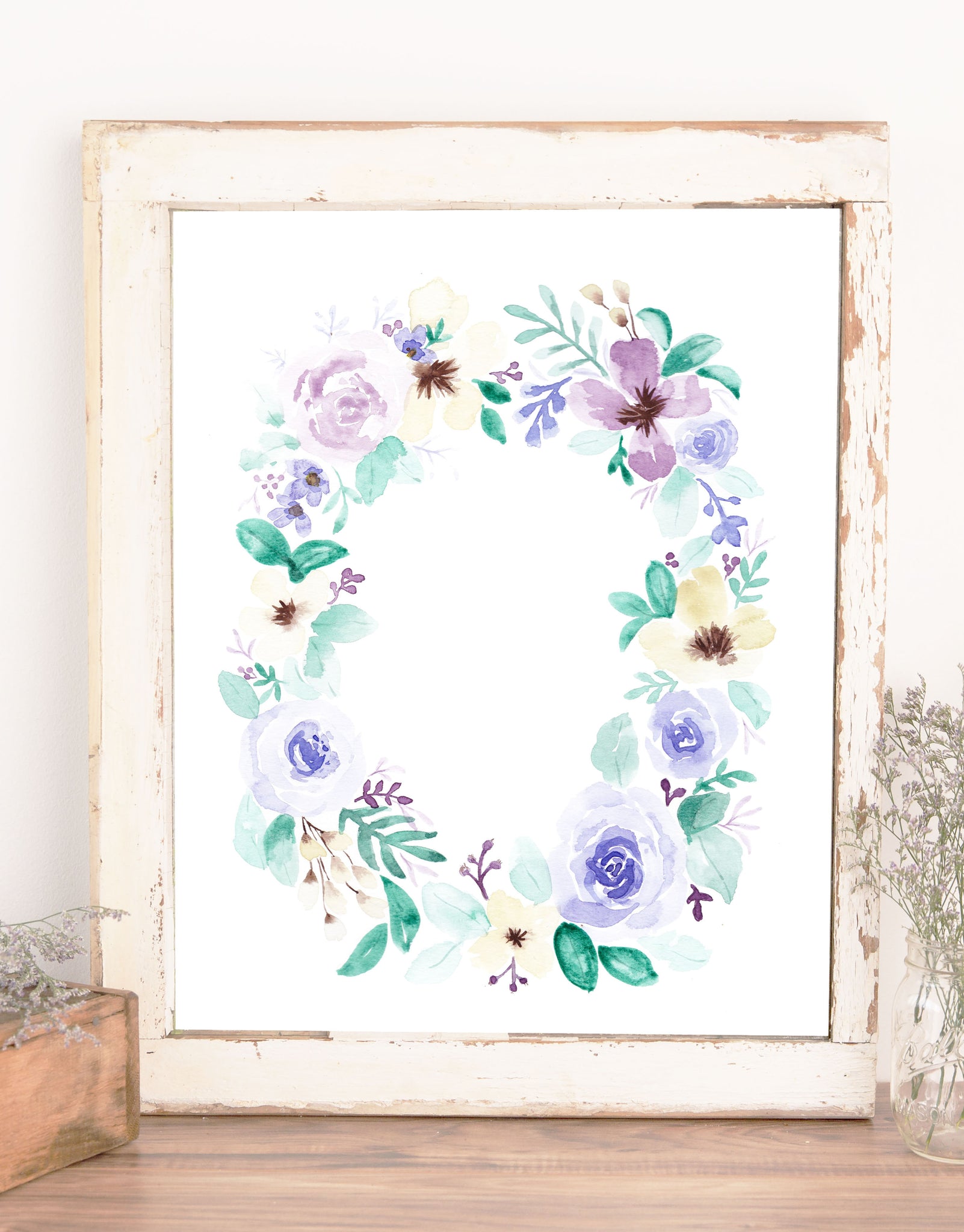 wall art of floral wreath with blue purple cream flowers and light and dark green leaves