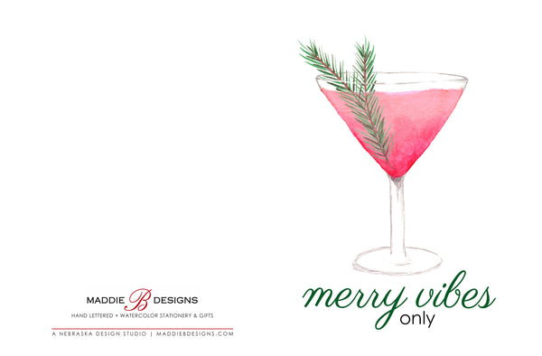 Watercolor greeting card with a watercolor christmas cocktail that says merry vibes only shown laying open and flat to show front and back of card