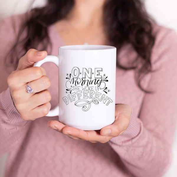 15oz white ceramic mug with hand lettered illustrated design that says I will become all that I was created to be shown with a woman holding the mug