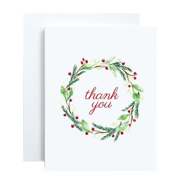 Watercolor Christmas greeting card with a holiday wreath of twigs, greens and berries in red and green that says thank you